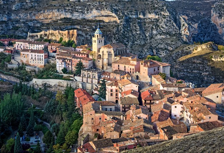 [SPAIN.ARAGON 28682]
’Albarracin and its castle.’

Albarracin is a beautifully preserved medieval town in the canyon of the Guadalaviar river in the southwest of Teruel province. Its castle (in the upper left part of the picture) is a Moorish fort (alcazaba) of the 10th century, built during the caliphate of Cordoba. In the 11th century the town became the capital of a taifa, an independent Muslim state ruled by the Banu Razin dynasty, whose family name would lend the town its name (Sahla Banu Razin). From 1170 till 1285 it was the capital of the small independent Christian kingdom of the Azagra family. Its medieval cathedral was remodeled in the 16th and 18th centuries. Photo. Mick Palarczyk.